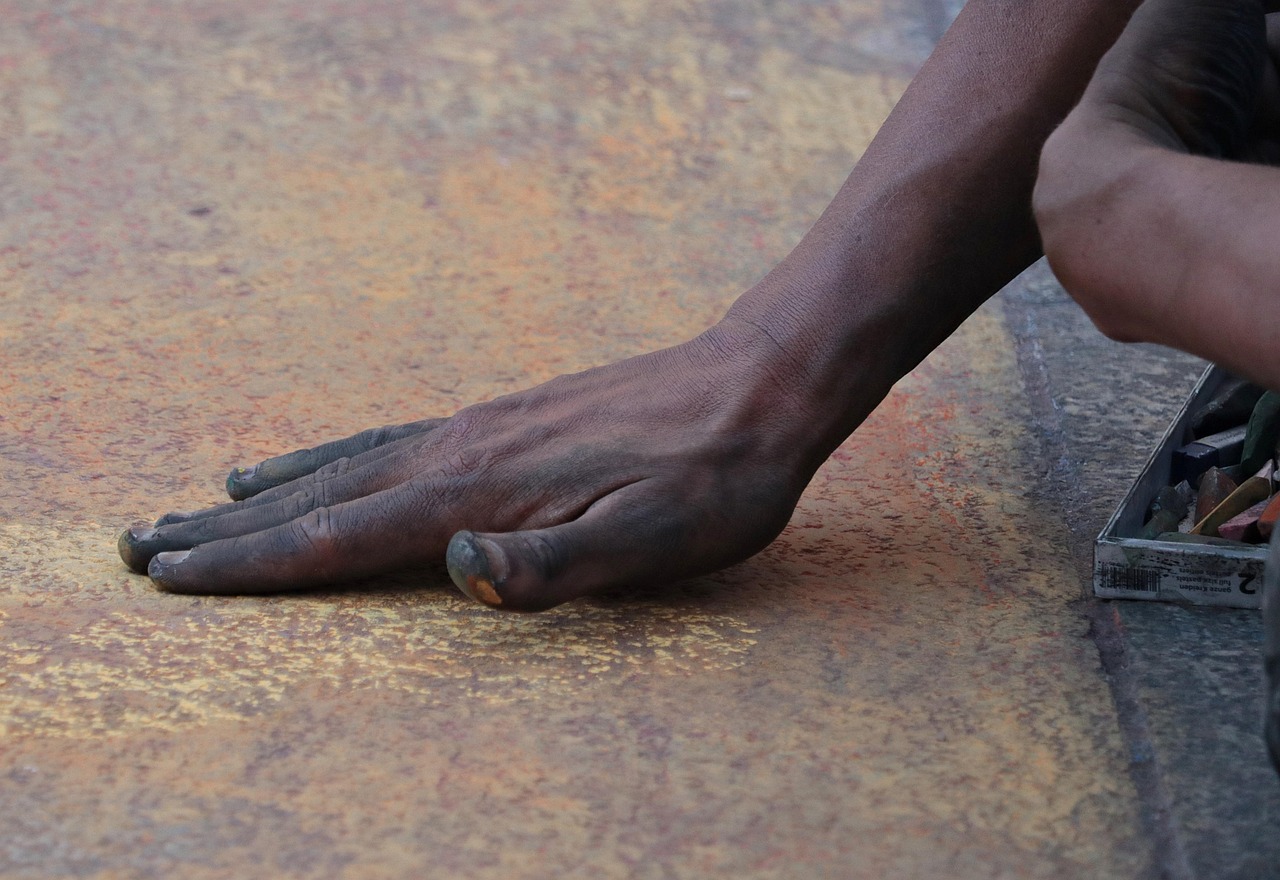 Hands working on a concrete floor surface