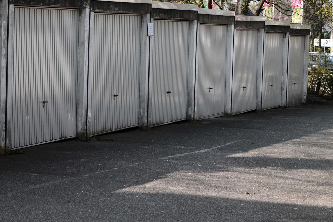 Row of garages along a concrete drive